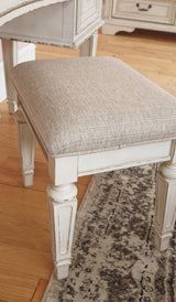 Realyn Queen Upholstery Panel Bed, Dresser, Chest, Nightstand, and Vanity Set