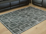 Furniture City Houma - Ashley Furniture - Elderland Washable 5' x 7' Area Rug - Washable 5' x 7' Area Rug / Black/Gray - R407402